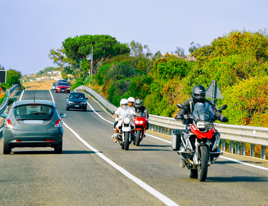 Multiple cars and motorcyles on the road