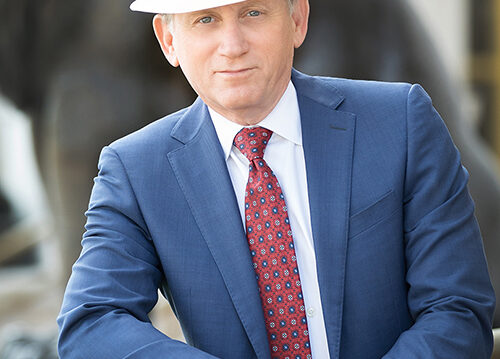 Portrait of David Kleinberg wearing a stylish hat, exuding confidence and sophistication.